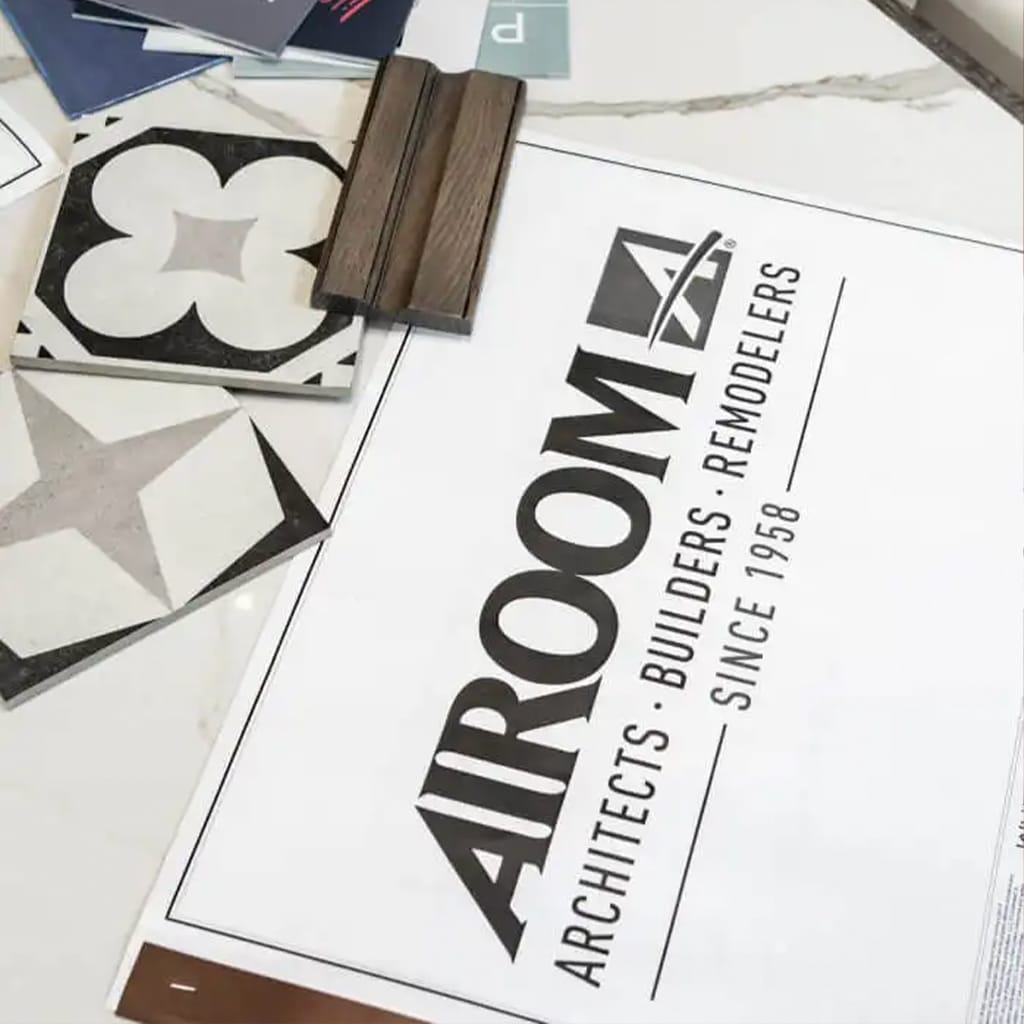An image of an Airoom booklet and tile samples laying on a table