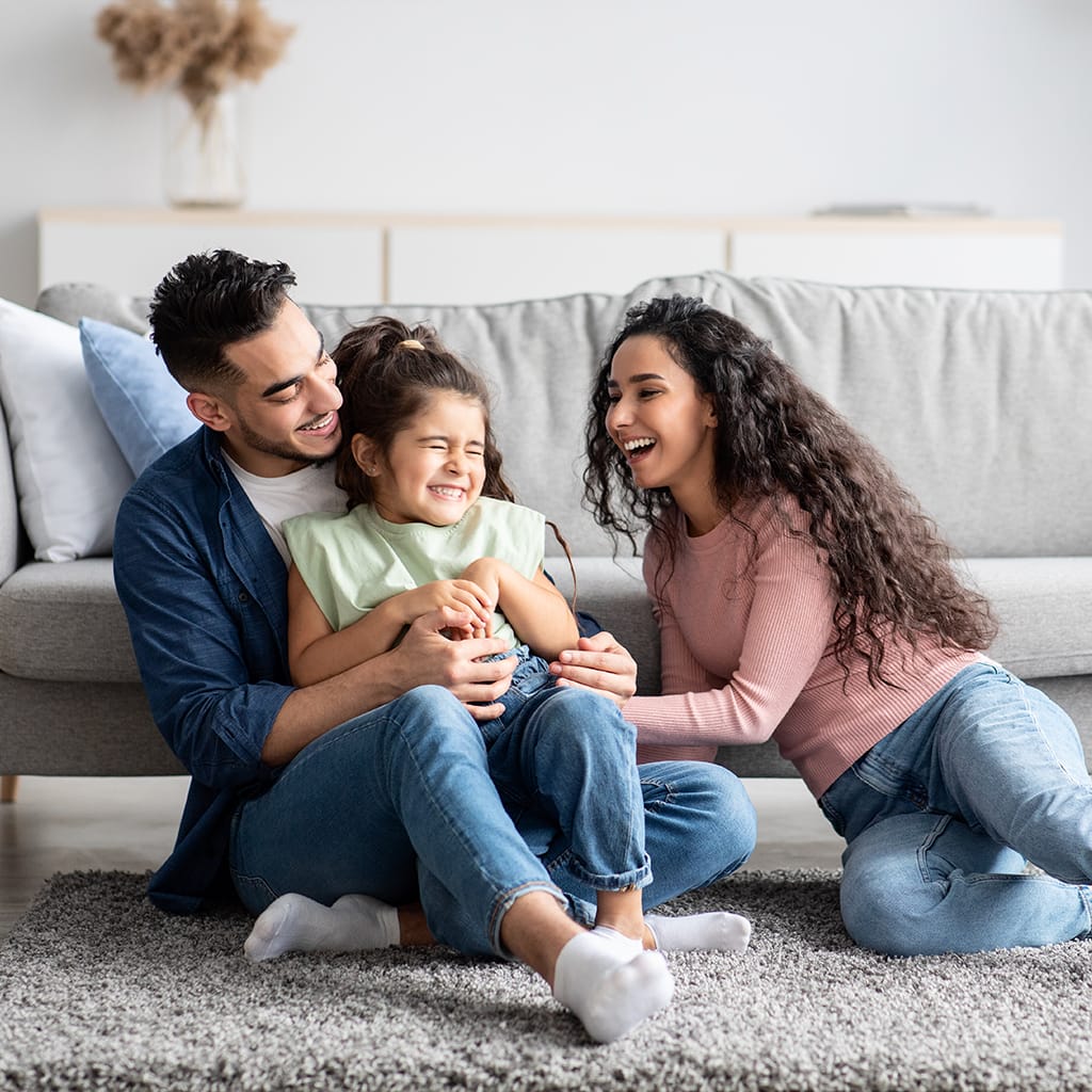 Image of a happy family in their living room | Airoom®