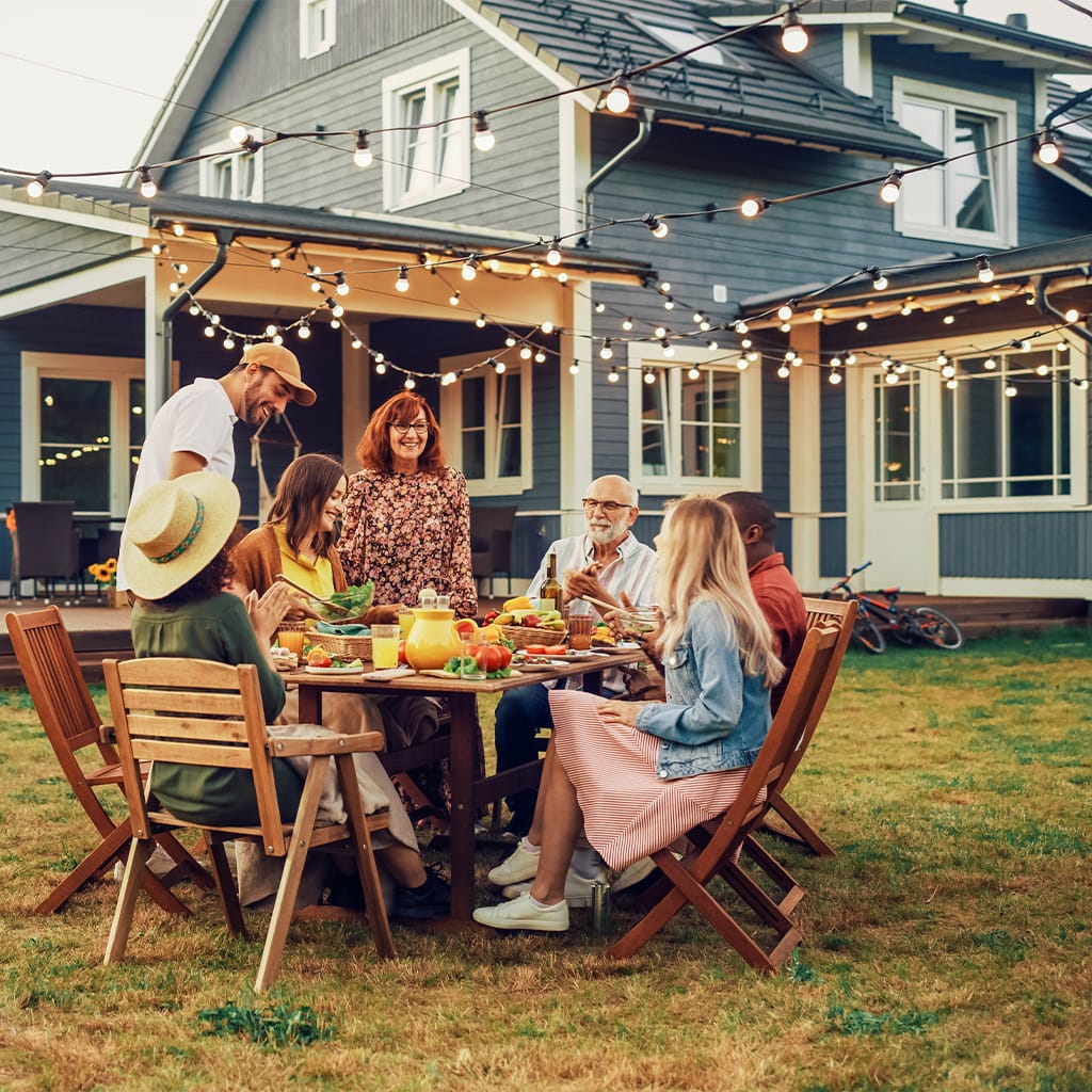 Image of a family enjoying their meal in the backyard | Airoom®