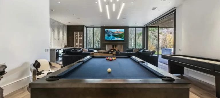 Living Room With Pool Table and Fireplace