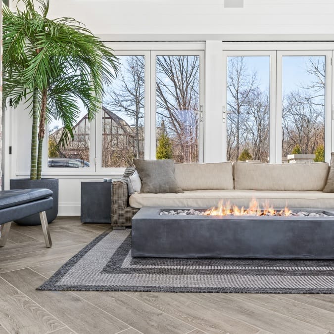 Indoor fire table to large windows adjacent