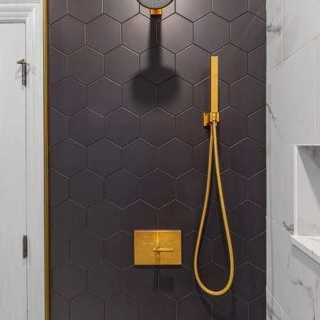Slate Gray Hexagon Tile in Shower with Gold Sprayer Finishes