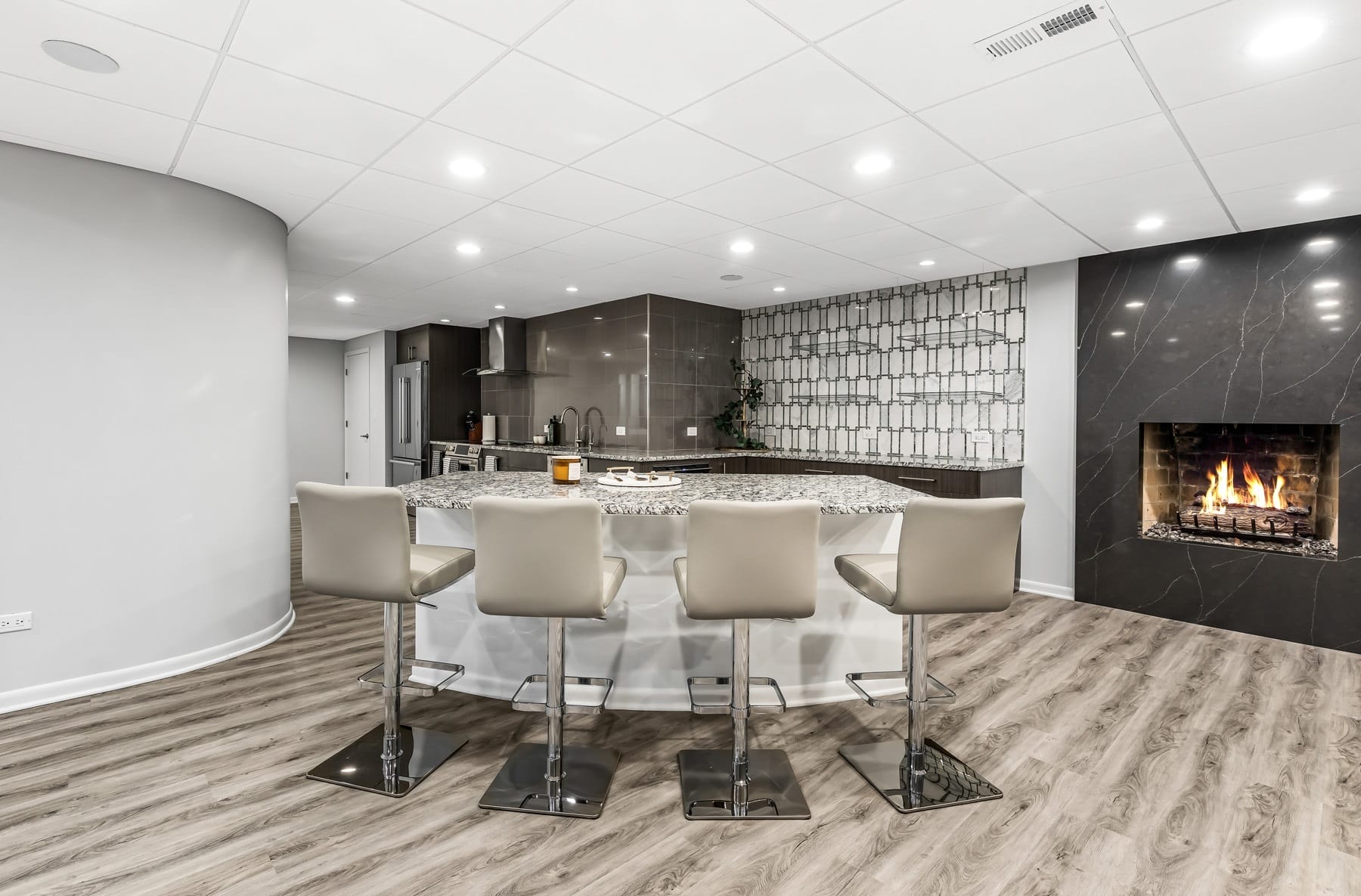 Modern Basement Featuring Luxury Vinyl Tile and a Fireplace